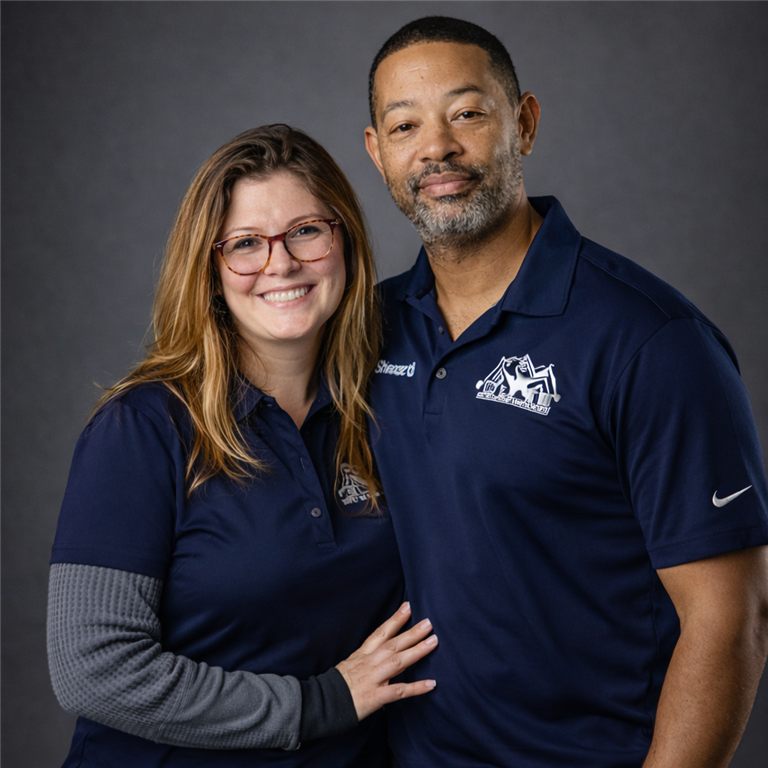 Richard and Chelsea of Elite Carpet, Tile and Grout Cleaning in matching navy Elite polo shirts